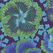 Vibrant fabric pattern featuring large green and blue flowers on a dark purple background.