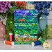 A stack of 20 vibrant fat quarters featuring green tropical patterns by Kaffe Fassett, with jars and flowers and thread.