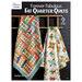 The front of the Forever Fabulous Fat Quarter Quilts book featuring two of the designs hung on a ladder.