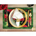 Elegant table setting featuring golden utensils with a white napkin on a floral placemat.