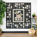 A patchwork quilt featuring a lion, tiger, and leopard, surrounded by geometric black and white animal prints.