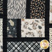 Up close of patchwork quilt featuring animal prints, plaid designs and black borders