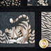 A close-up of a quilt featuring a playful tiger design and other animal themed prints