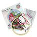 The packaging, contents of the cross stitch kit, and pattern displayed on a white background. 