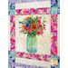 Up close of a vibrant patchwork quilt featuring a boutique of flowers in a jar bordered by watercolor floral fabrics.