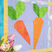 A close up on the patchwork carrots, demonstrating fabric, piecing, and top quilting details.