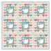 A quilt design featuring blocks of doves bordered by colorful hearts.