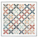 The completed Quadrangle Quilt, a geometric patchwork design colored in subtle floral fabrics from the Sandalwood collection, isolated on a white background.