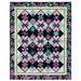 The completed Belle Kaleidoscope quilt colored in purple and aqua floral fabrics from Shizuka, isolated on a white background.