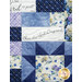 A patchwork quilt featuring floral patterns in blue tones with scripture verse panels. 