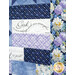 A patchwork quilt featuring floral patterns and panels with inspirational text.