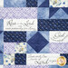 A patchwork quilt featuring blue tones and floral designs with panels that read scriptural bible verses.