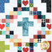 Up close of a colorful quilt featuring a geometrical pattern with cross shapes and heart motifs.