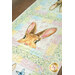 A colorful table runner featuring a rabbit's face surrounded by pastel floral patterns.