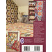 A cozy room showcasing a patchwork quilt on the floor and colorful quilts on a shelf.