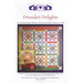 The front of the Dresden Delights pattern with the finished quilt and coordinating pillow isolated on a white background.