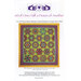 A colorful quilt pattern featuring hexagonal and star designs