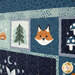 A close up on the panel border, showing various blocks with forest motifs, elements, and stylized illustrations of sleepy and nocturnal animals.