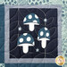 A super close up on one of the panel blocks, featuring three adorable stylized mushrooms in navy and white.