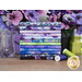 A stack of the fabrics featured in the Pansy Perfection FQ set, with pansies and vases and a flower pot and thread.