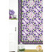 A shot of the bottom left corner of the quilt bordered by a white dresser decorated with coordinating purple florals and decor.