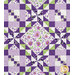 A close up on one of the floral blocks, demonstrating fabric, piecing, and top quilting details.
