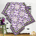 A shot of the quilt draped artfully over a white dresser, demonstrating form and dimension.