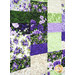 A super close up on the patchwork of the quilt, demonstrating fabric colors, prints, and details.