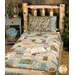 A patchwork quilt in earthy tones covers a bed, complemented by a textured pillow and surrounded by coordinating woodsy decor. 