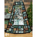 A shot of the panel quilt artistically draped over a wooden ladder to show dimension and movement. Coordinating forest and camping decor sits behind the quilt.
