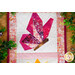 A close up on the top butterfly surrounding by decorative leaves, demonstrating fabric, piecing, border, and binding details.