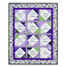 The completed Forever Sisters Charm Quilt colored in vibrant purple, green, and cream fabrics from the Georgina collection, isolated on a white background.
