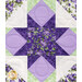 An up close shot of a patchwork quilt featuring a star-shaped design with purple and green floral patterns.