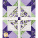 Close-up of a patchwork quilt block featuring floral patterns in green and purple colors.