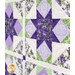 An angled close up of the quilt, demonstrating fabric, piecing, sashing, and stitching details.