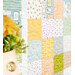 Colorful patchwork quilt featuring various pastel patterns, with a bouquet of yellow flowers in the foreground.