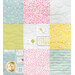 Up-close of the patchwork quilt featuring nine fabric squares in various colors and patterns, including florals and playful motifs.