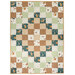 A patchwork crib quilt in creams, browns, and greens featuring whimsical animal and floral patterns isolated on a white background.