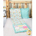 A shot of the quillow more unfolded featuring playful cat designs staged on a bed with matching fabrics.