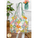Colorful patchwork tote bag with floral designs from the Sunday Brunch collection by Tilda, hung on a white chair with coordinating decor.