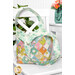 The midi bag with the handles slightly draped, showing the white lining fabric with mint green florals.