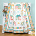 A head on shot of the quilt, artfully draped over a white armoire to demonstrate flow and form.