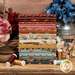 stacked photo of the Farmer's Daughter fabrics staged next florals and thread spools.