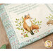 A close up on the open panel book, showing details on a cute fox.