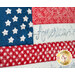 Close-up of a quilt featuring the American flag with star-shaped embellishments and the word America.