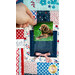 A photo of someone inserting a photo of a dog into a decorative quilted fabric pocket.