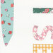 Colorful fabric swatches featuring strawberries, flowers, and patterns in pastel colors.
