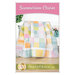 Front cover showing the completed Summertime Charm quilt draped over a white bench with coordinating flowers and decor.