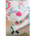 A colorful quilt featuring geometric patterns is layered on a bed, with a folded quilt on top.