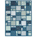 A blue patchwork quilt featuring woodland animal prints in blue shades isolated on a white background. 